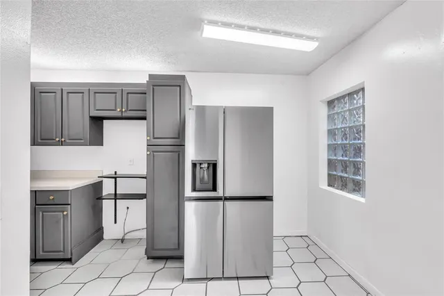 a kitchen with stainless steel appliances a refrigerator and a stove top oven