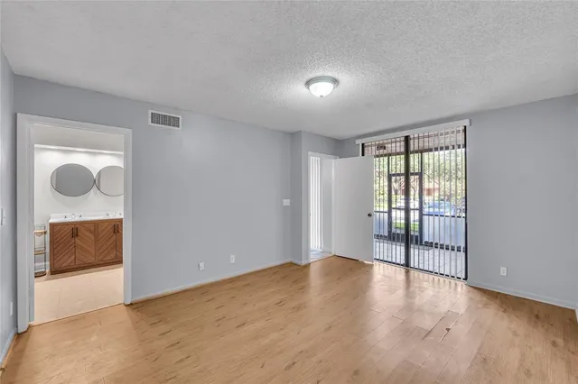 a view of an empty room and glass door