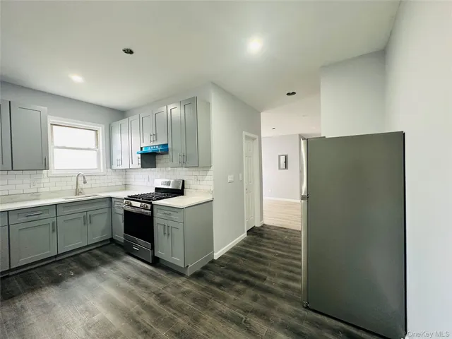 a kitchen with a refrigerator and a sink