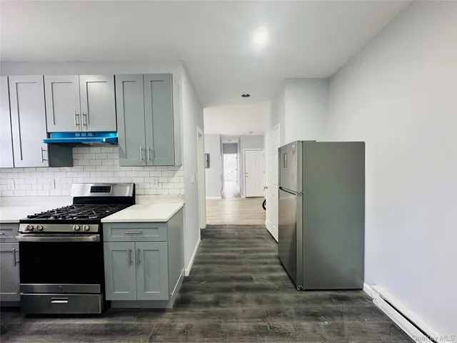 a kitchen with a refrigerator and a stove