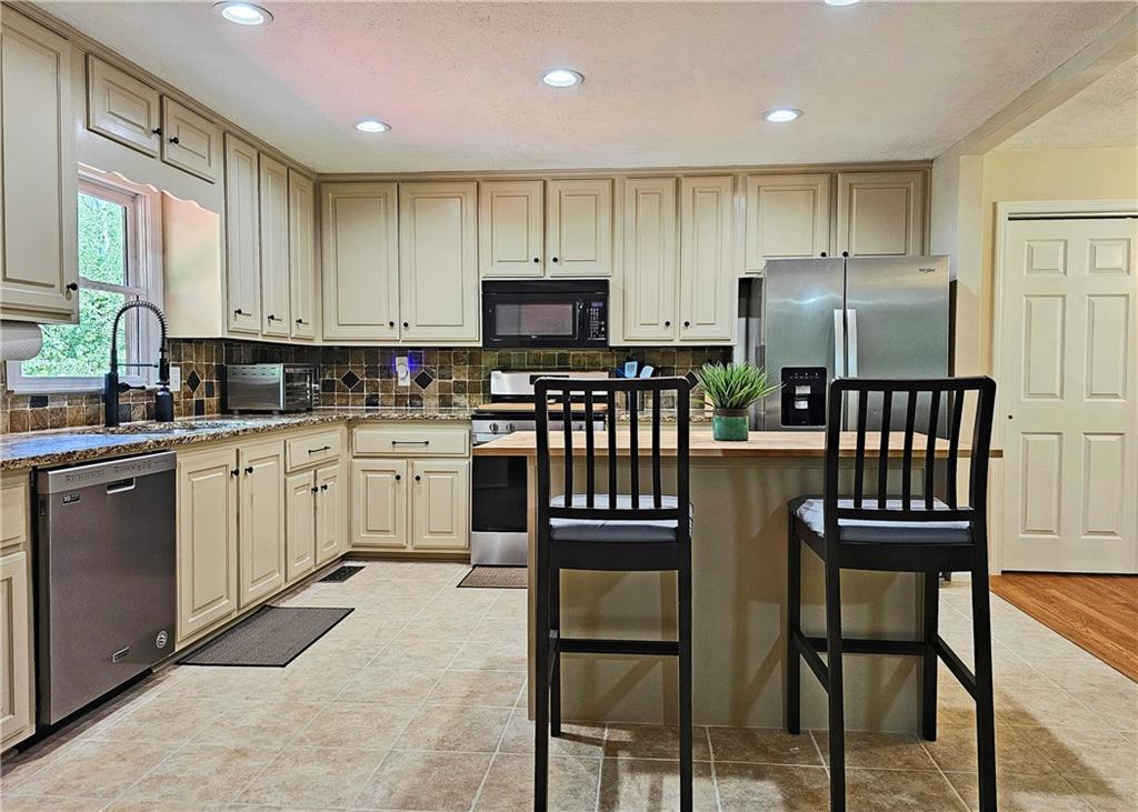 a kitchen with cabinets a sink and stainless steel appliances