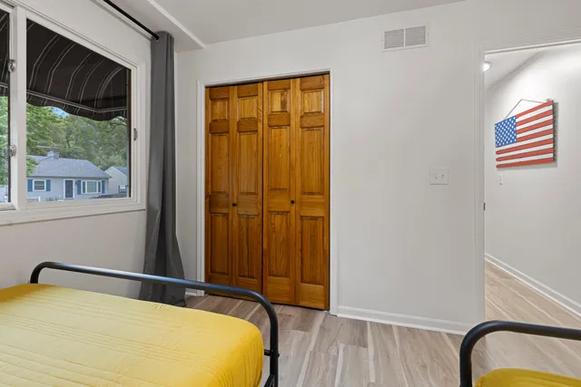 a bedroom with a bed and a window