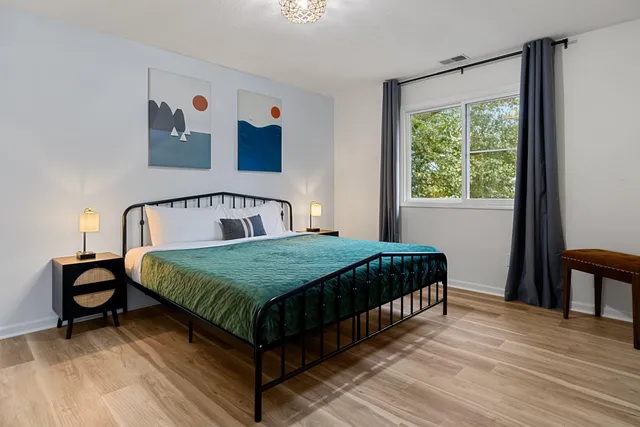 a bedroom with a bed and window