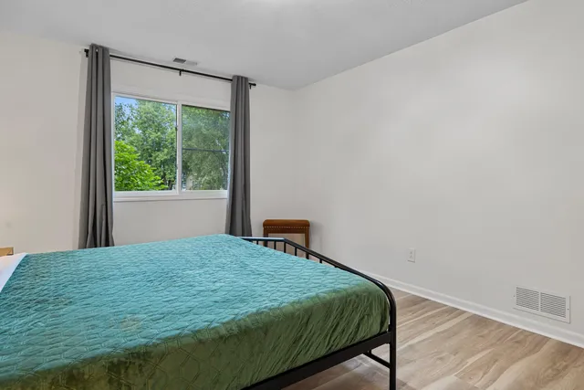 a bedroom with a bed and a window