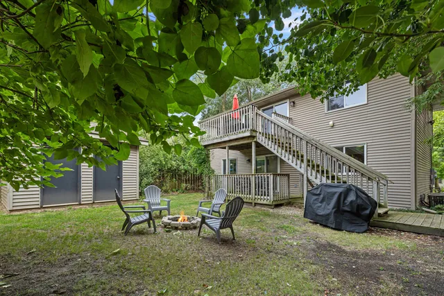 a view of a house with backyard and sitting area