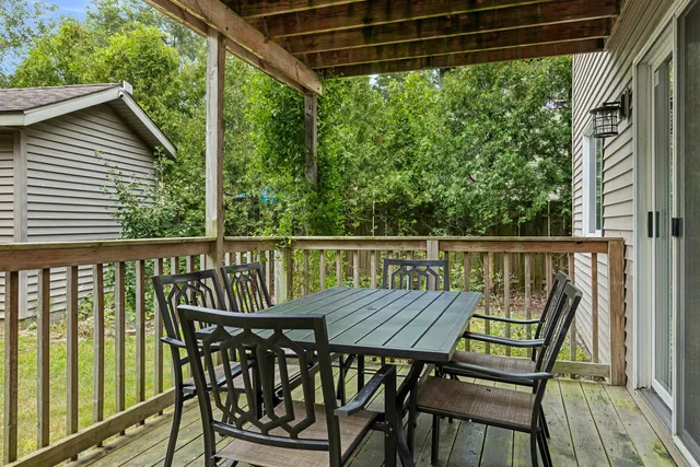 a view of a wooden deck with a table and chairs