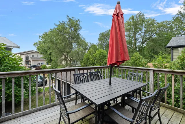a deck with a table and chairs
