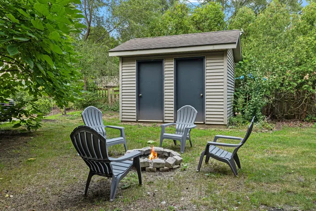 a view of a chairs in backyard of the house