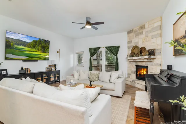 a living room with furniture a fireplace and a flat screen tv