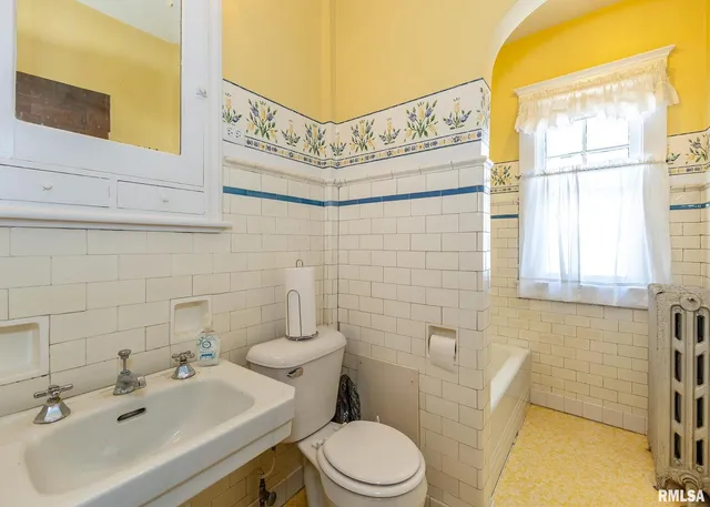 a view of a bedroom with furniture and closet