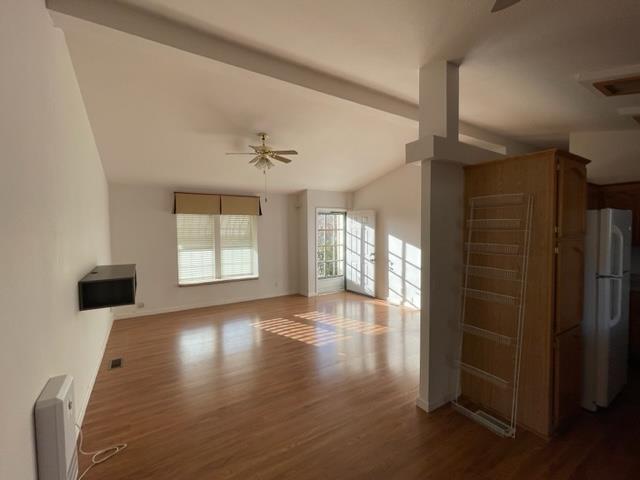 166 Oak Tree Circle Murphys, CA 95247 - Photo 3 of 21 a view of an empty room with wooden floor and a window