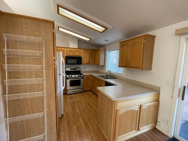 166 Oak Tree Circle Murphys, CA 95247 - Photo 5 of 21 a kitchen with a refrigerator sink and microwave