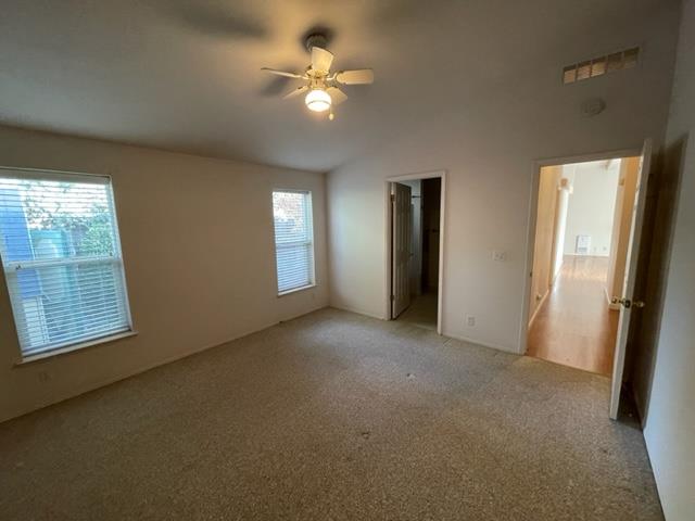 166 Oak Tree Circle Murphys, CA 95247 - Photo 8 of 21 an empty room with windows and fan