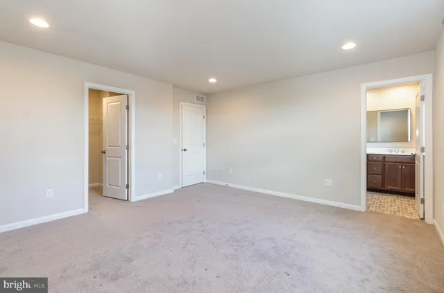 an empty room with a bathroom and a sink