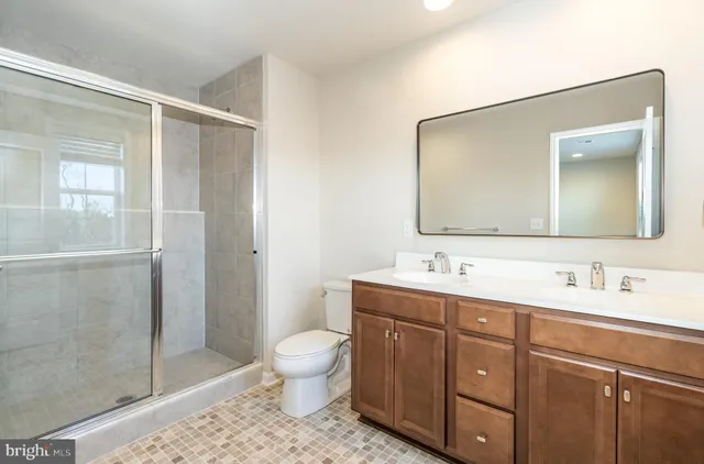 a bathroom with a toilet sink and shower