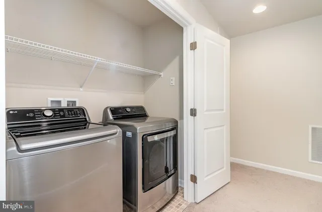 a view of storage and utility room with washer and dryer