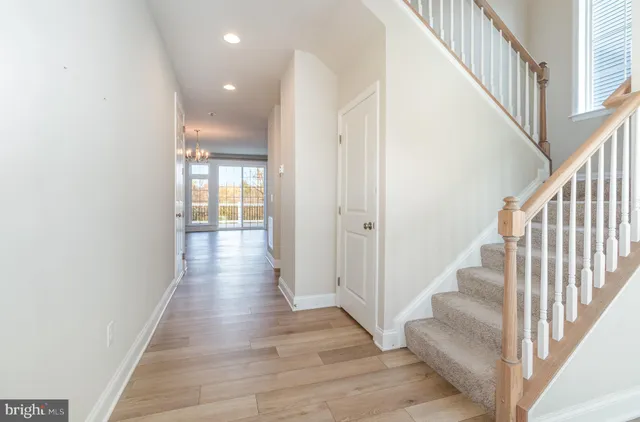 a view of an entryway with wooden floor