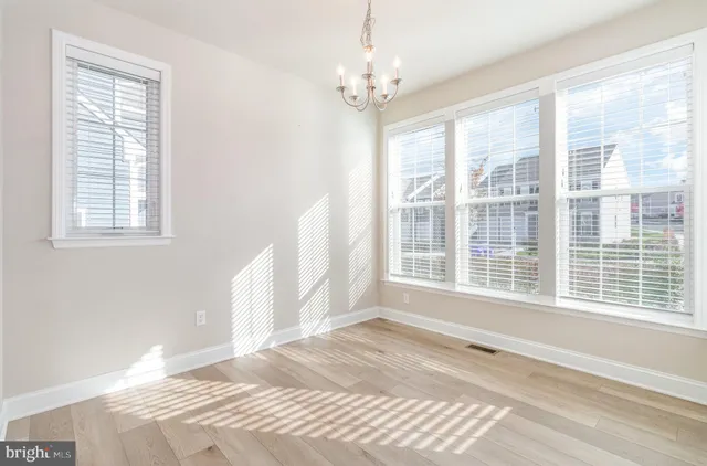 a view of a bedroom with a window and wooden floor