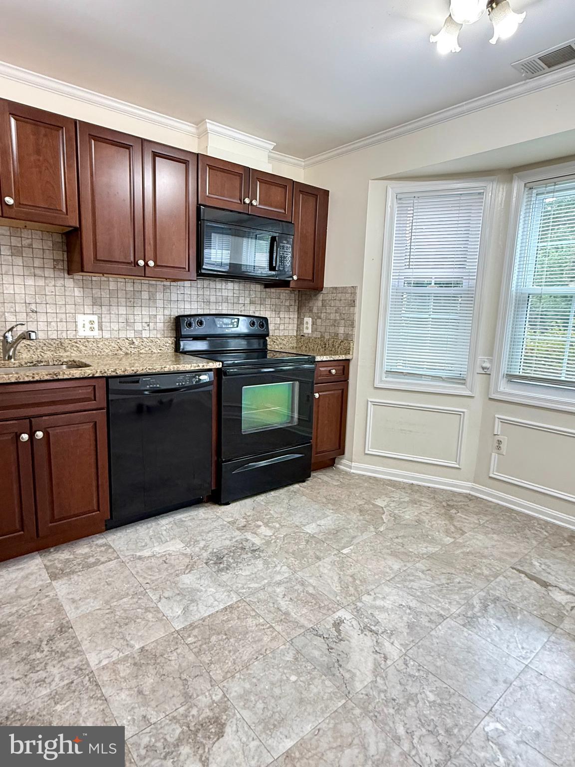 6029 Selwood Place Springfield, VA 22152 - Photo 5 of 16 a kitchen with stainless steel appliances granite countertop a stove top oven a sink dishwasher a refrigerator and cabinets with wooden floor