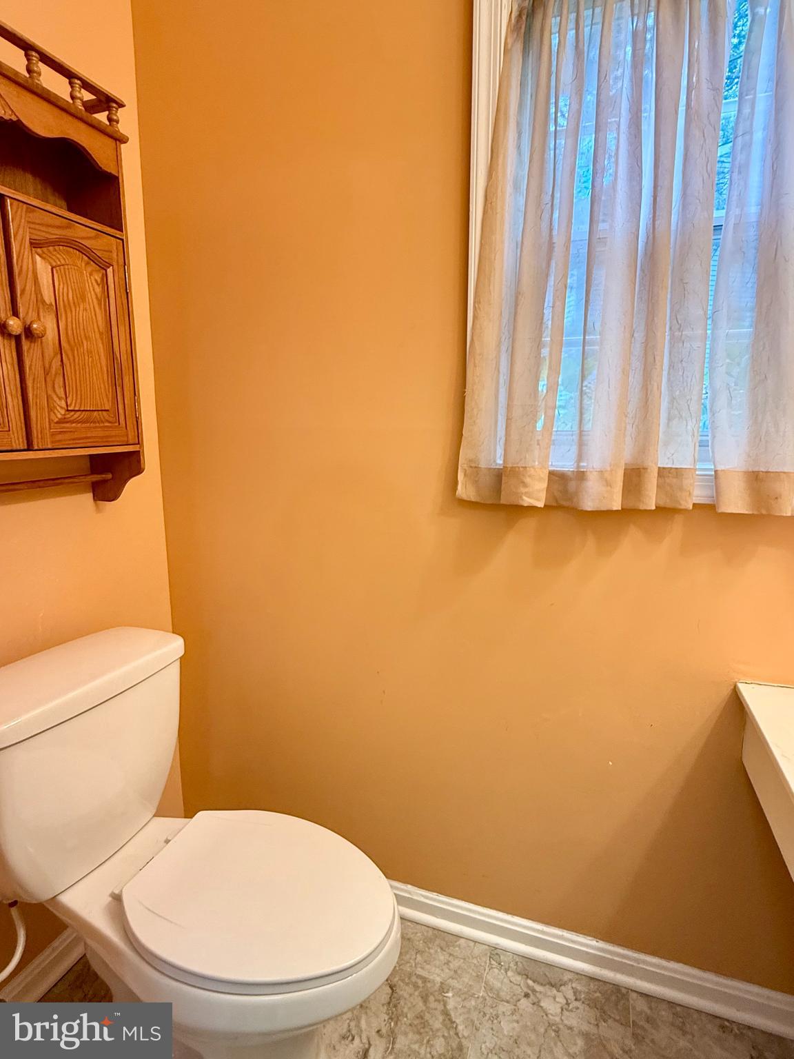 6029 Selwood Place Springfield, VA 22152 - Photo 8 of 16 a white toilet and sink sitting in a bathroom