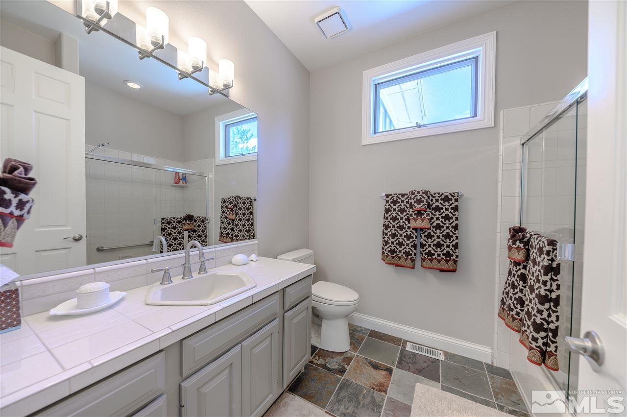 10 Sharps Circle Reno, NV 89519 - Photo 16 of 21 a bathroom with a sink a toilet a mirror and shower