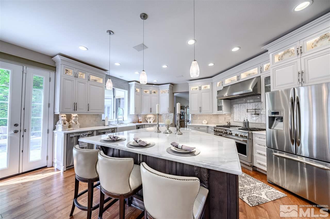 10 Sharps Circle Reno, NV 89519 - Photo 7 of 21 a kitchen with a sink a kitchen island and stainless steel appliances