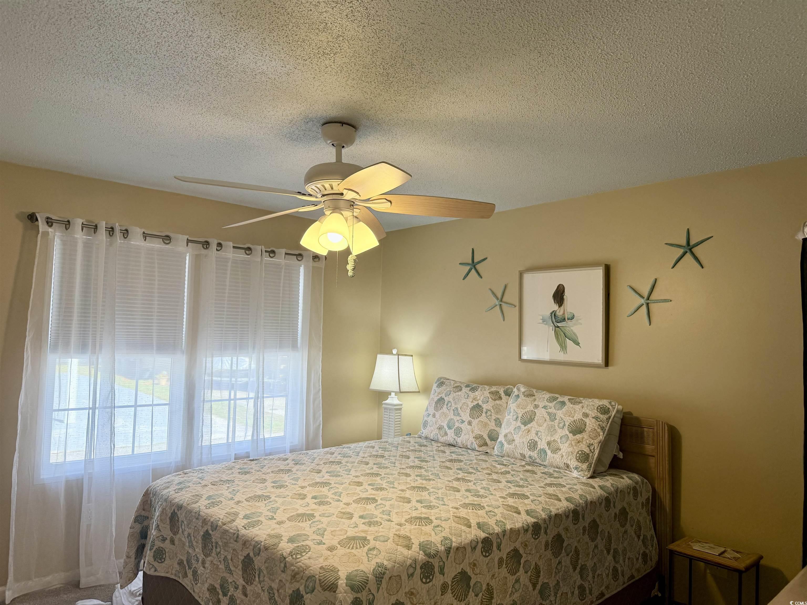 427 Meadowlark Surfside Beach, SC 29575 - Photo 20 of 33 Bedroom with a textured ceiling and ceiling fan