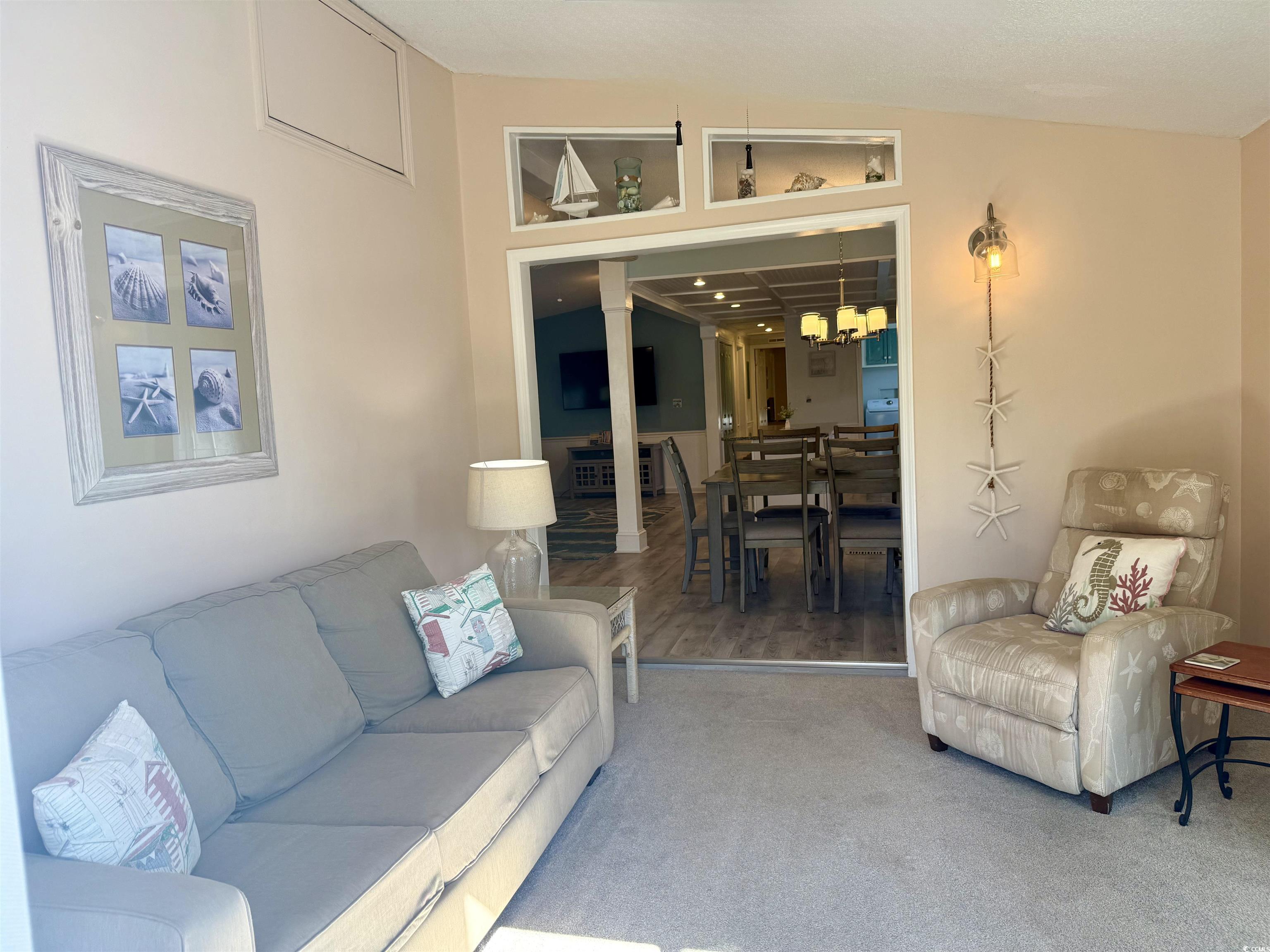 427 Meadowlark Surfside Beach, SC 29575 - Photo 6 of 33 Carpeted living area with a chandelier