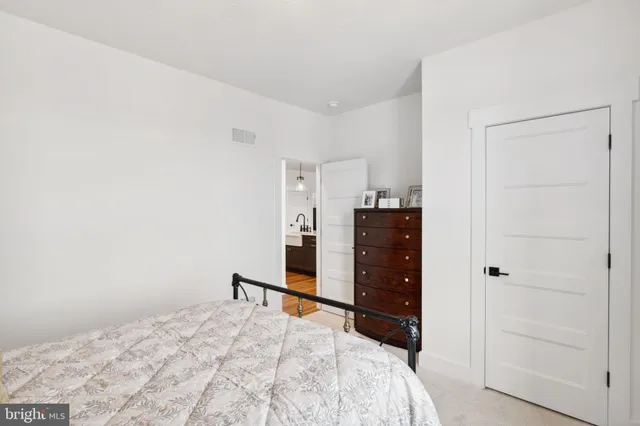 a bedroom with a bed and a dresser
