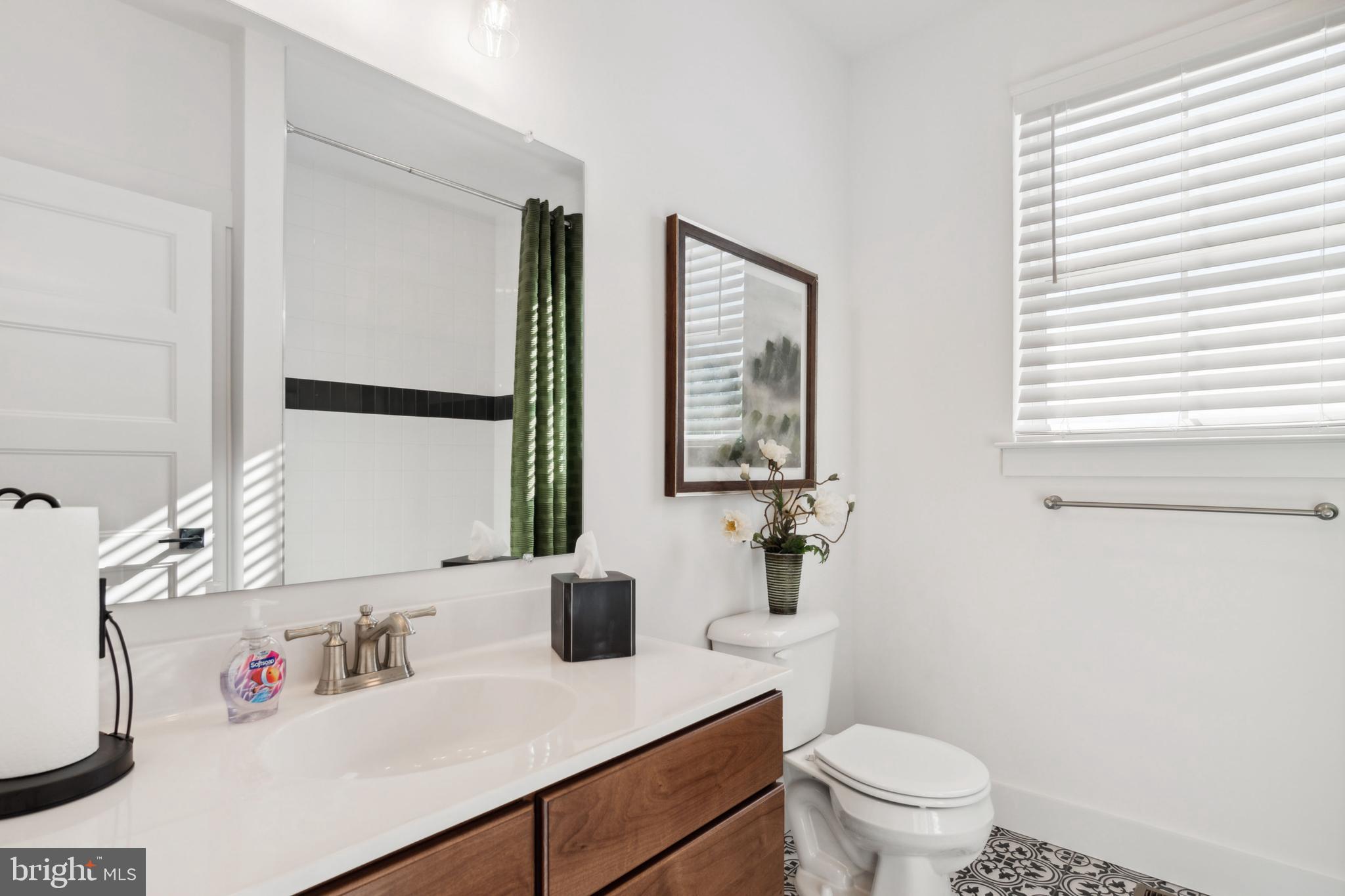 1133 Westminster Avenue, Unit 4 Hanover, PA 17331 - Photo 20 of 26 a bathroom with a sink toilet and mirror