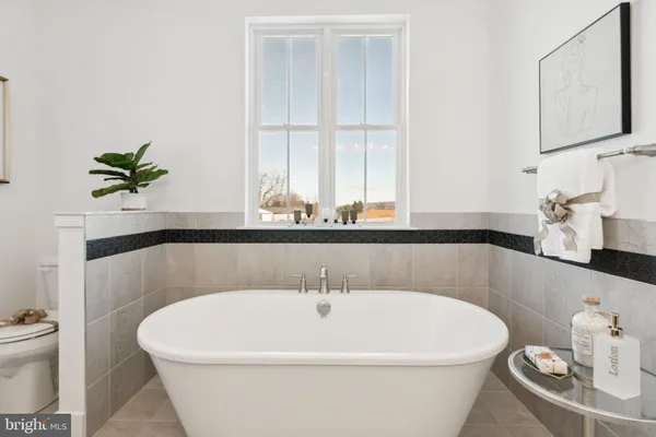 a white bath tub sitting next to a white toilet