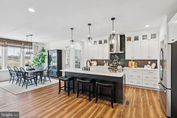 a large kitchen with a table and chairs