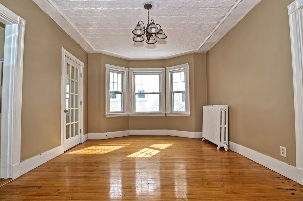 a view of a livingroom with wooden floor and a window