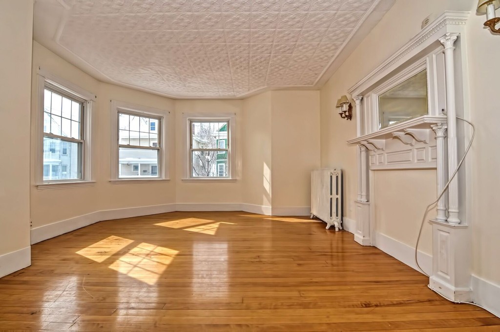 40-42 Mapleton Street Boston, MA 02135 - Photo 6 of 17 a view of empty room with wooden floor and fan