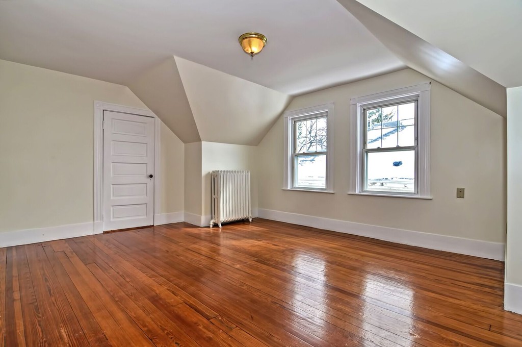 40-42 Mapleton Street Boston, MA 02135 - Photo 7 of 17 a view of an empty room with wooden floor and a window