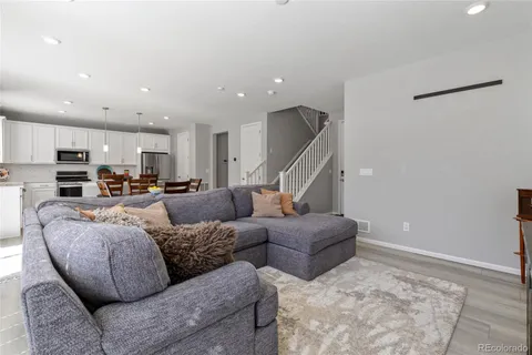 a living room with furniture and kitchen view
