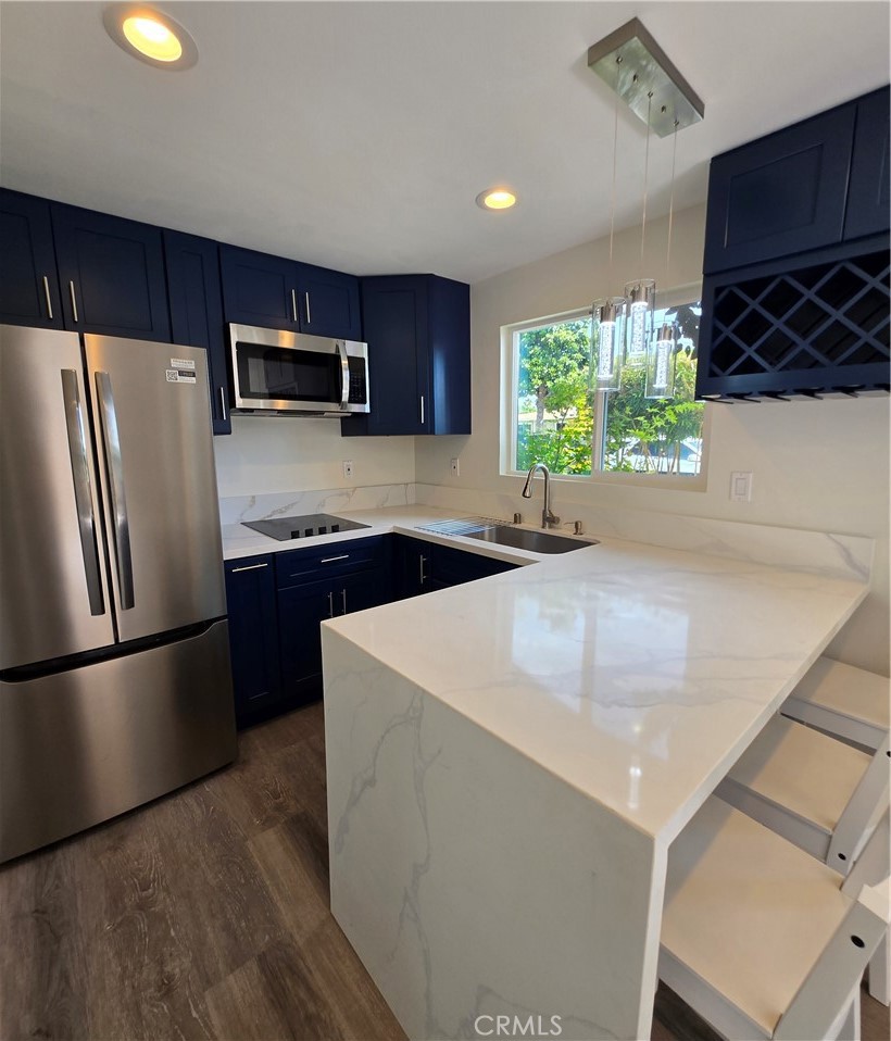 a kitchen with stainless steel appliances a microwave sink and refrigerator