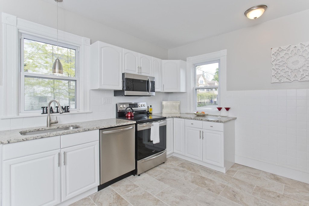 4 Rittenhouse Terrace Springfield, MA 01108 - Photo 1 of 30 a kitchen with white cabinets appliances a sink and a window