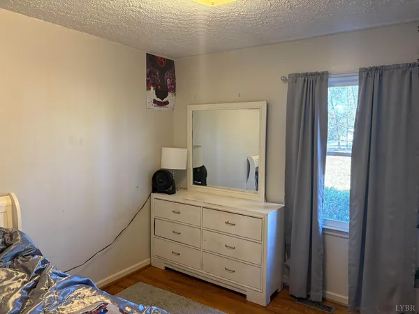 a room with a bed and a mirror