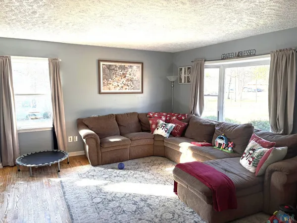 a living room with furniture window and wooden floor