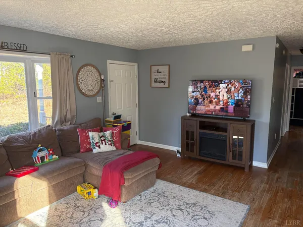 a living room with furniture a rug and a fireplace