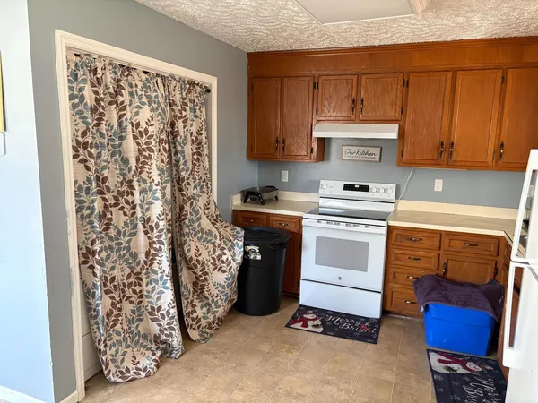 a kitchen with stainless steel appliances a stove a sink and a refrigerator