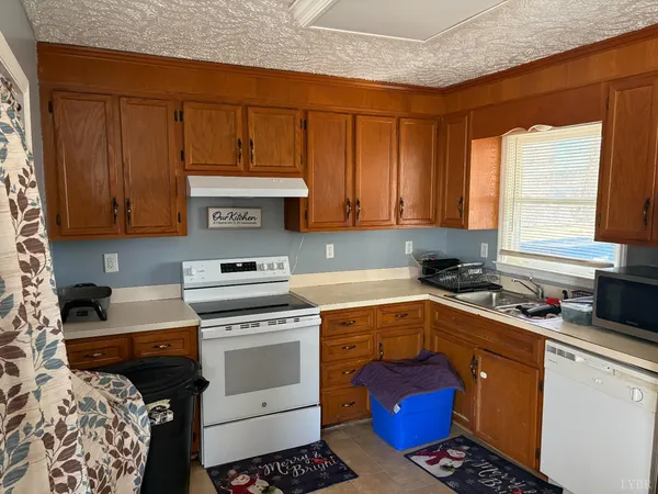 a kitchen with a stove a sink and a microwave
