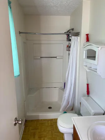 a bathroom with a toilet and a shower
