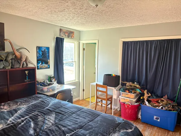 a bedroom with bed chair and window