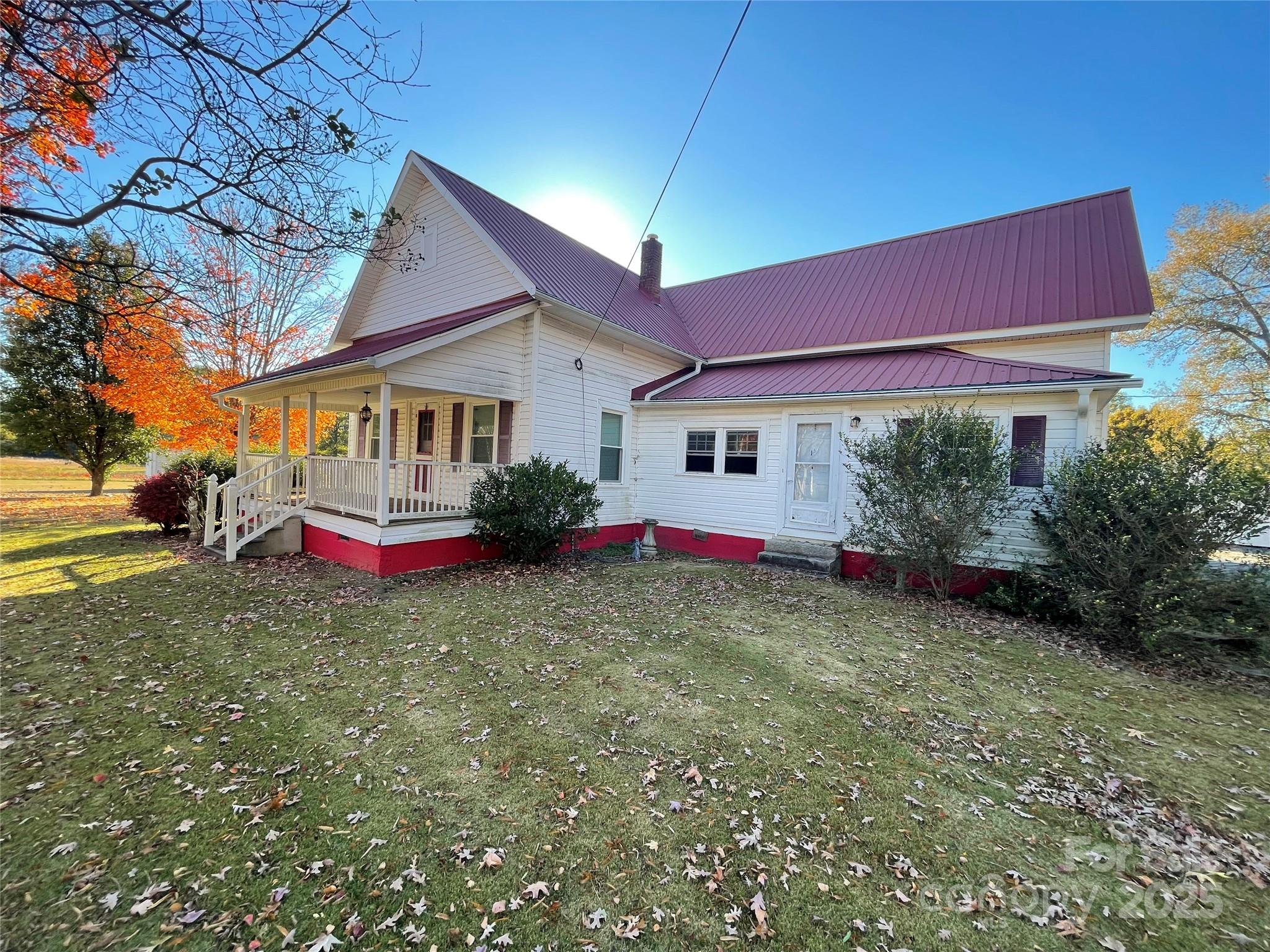 2865 Lentz Road China Grove, NC 28023 - Photo 14 of 16 a view of a white house with a small yard and large tree