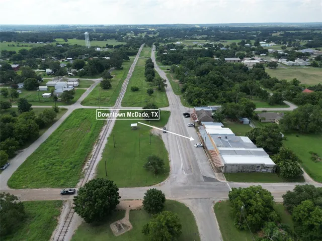 an aerial view of a residential houses with outdoor space and street view