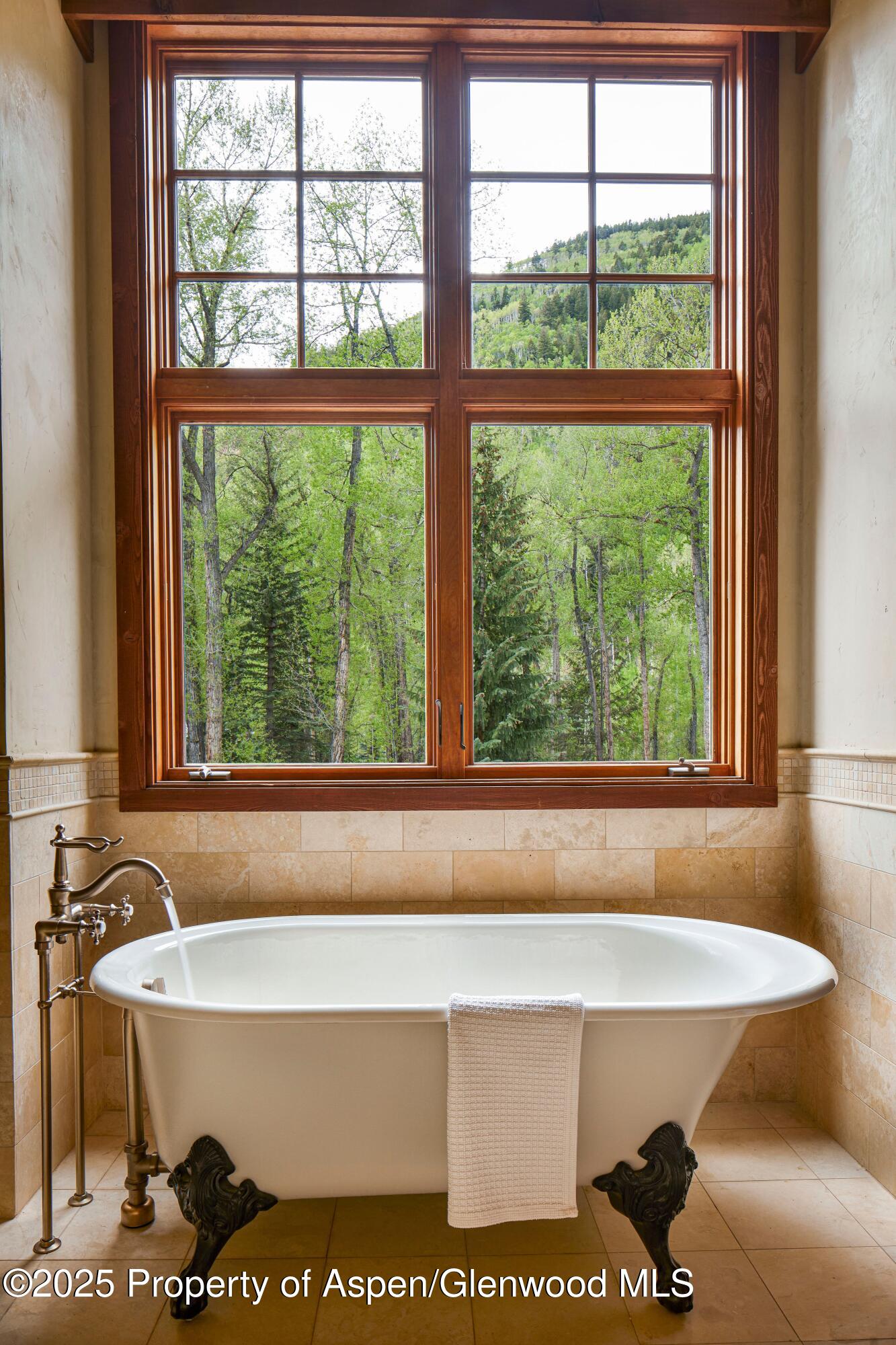 143 Conundrum Creek Road Aspen, CO 81611 - Photo 17 of 19 a bathroom with a bathtub and window