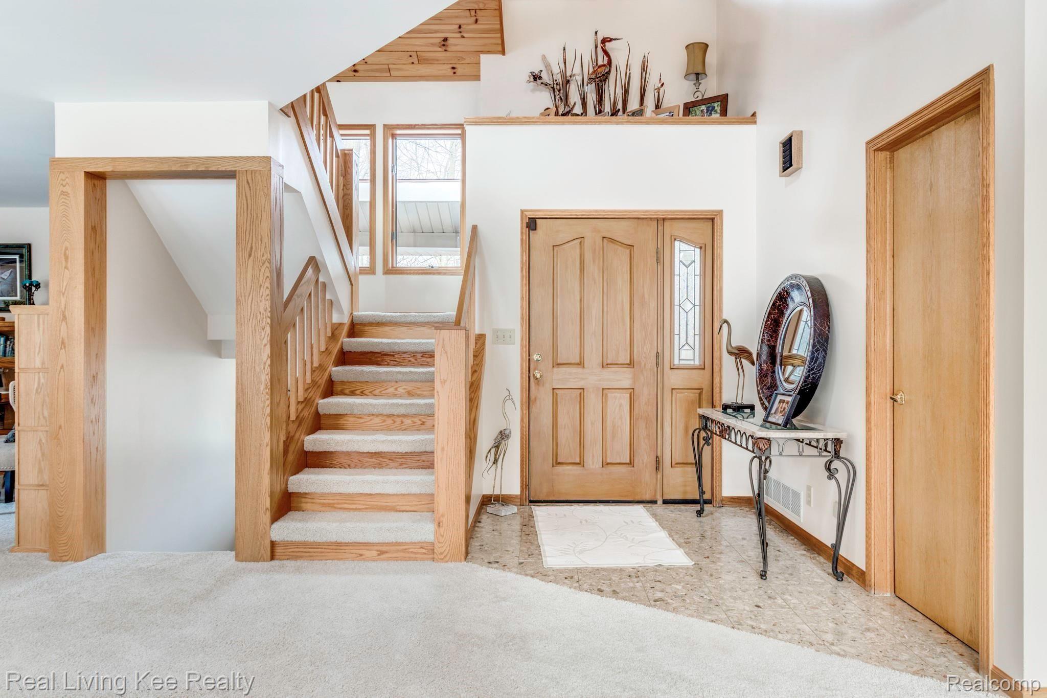 5775 McIntyre Road North Street, MI 48049 - Photo 12 of 65 5775 McIntyre Rd entryway and staircase as one is looking at front door under about the middle of house. Kitchen to right.JPG