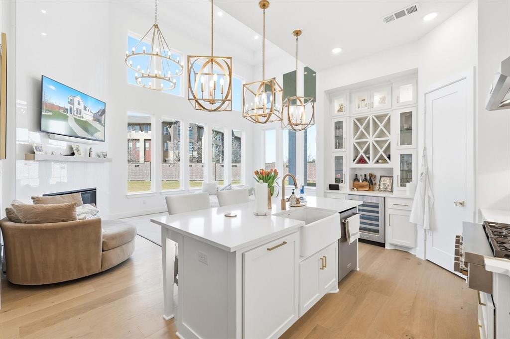16194 Inca Dove Court Frisco, TX 75035 - Photo 14 of 40 Open Kitchen features wine storage and KitchenAid wine refrigerator.